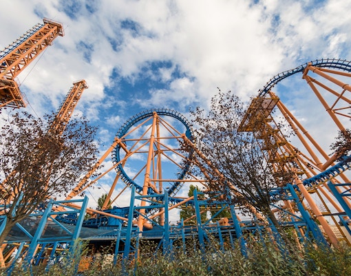 Roller coaster at Parque de Atracciones, Madrid, with riders enjoying the thrill.