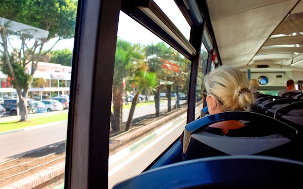 Bus ride from Ibiza Airport to Ibiza city with passengers seated.