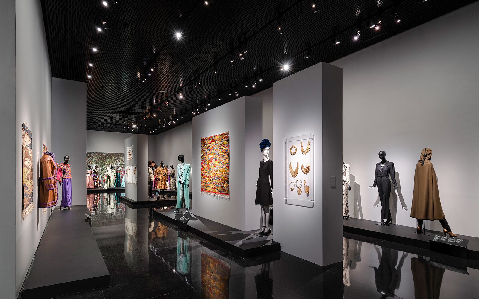 Fashion exhibit at YSL Museum in Marrakech showcasing designer clothing and accessories.