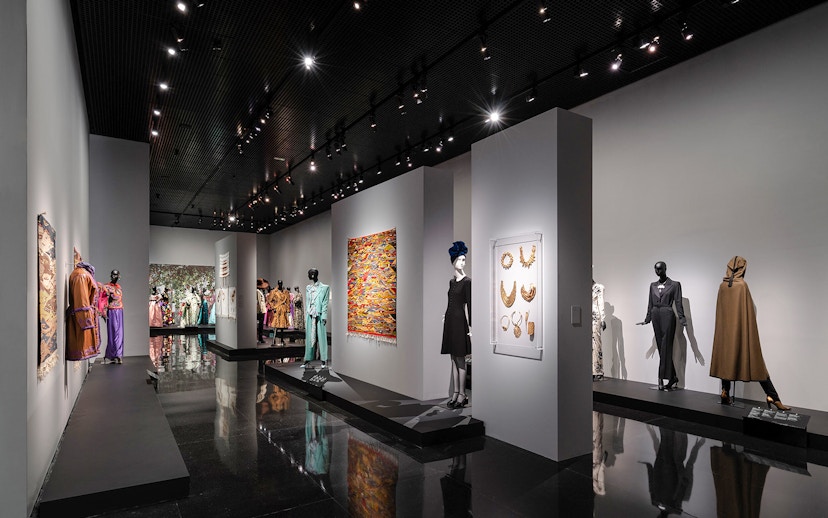 Fashion exhibit at YSL Museum in Marrakech showcasing designer clothing and accessories.