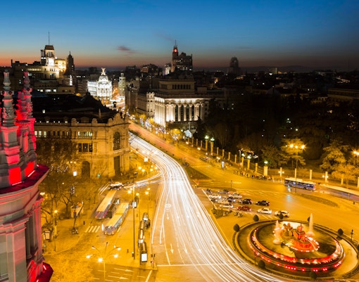 Plaza de Cibeles in Madrid, Spain, illuminated at night with city lights.