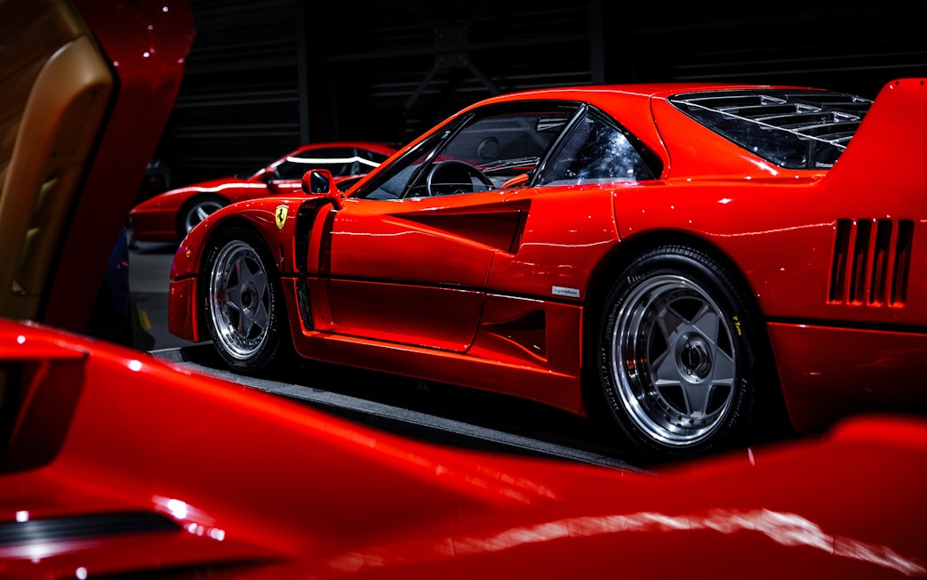 Red sports car on display at Coligny Car Museum, Lyon, France.