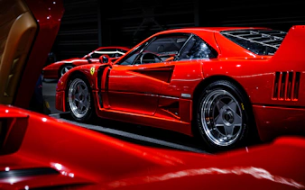 Red sports car on display at Coligny Car Museum, Lyon, France.
