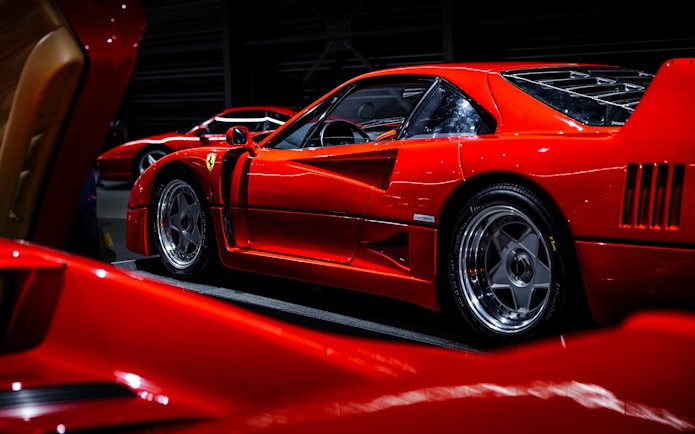 Red sports car on display at Coligny Car Museum, Lyon, France.