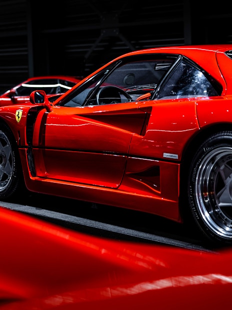 Red sports car on display at Coligny Car Museum, Lyon, France.