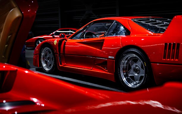 Red sports car on display at Coligny Car Museum, Lyon, France.