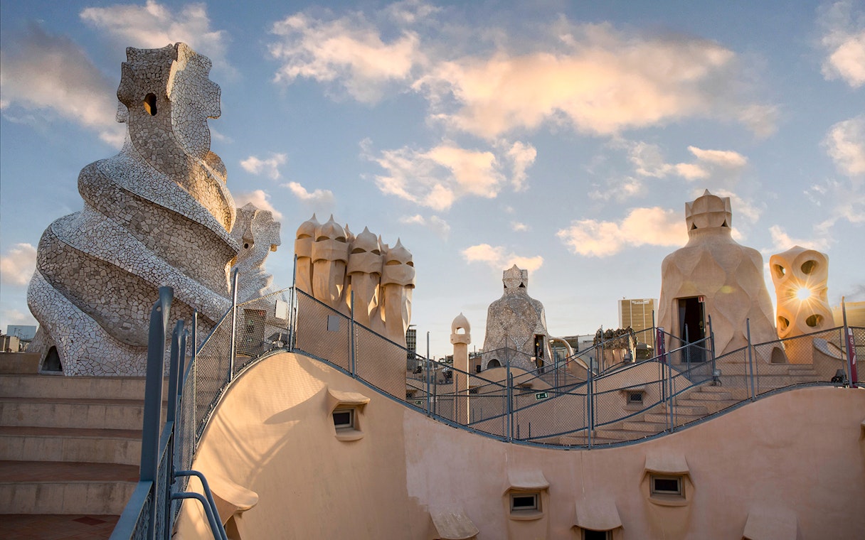 Casa Milà rooftop chimneys at sunrise during La Pedrera tour in Barcelona.