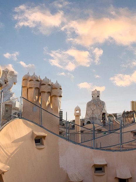 Casa Milà rooftop chimneys at sunrise during La Pedrera tour in Barcelona.