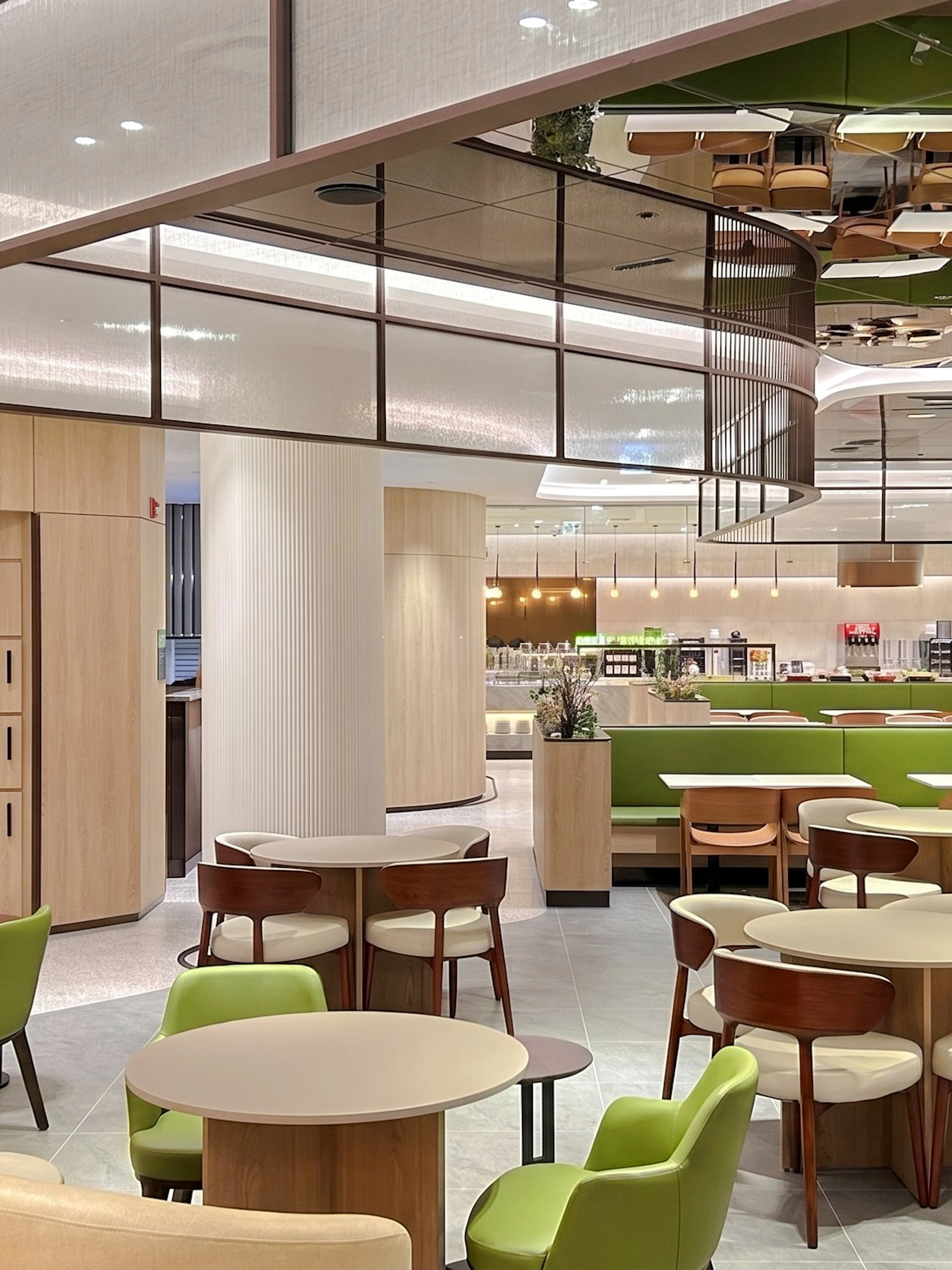 Sky Hub Lounge West seating area with tables, chairs, and luggage lockers.