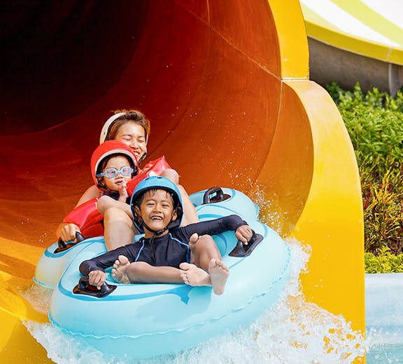 Children enjoying a water slide at Caribe Aquatic Park.