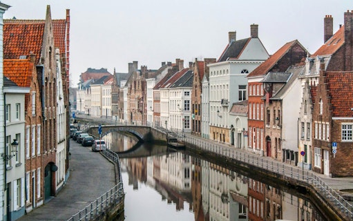Historic canals and medieval buildings in Bruges, Belgium.