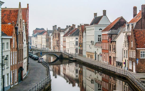 Historic canals and medieval buildings in Bruges, Belgium.