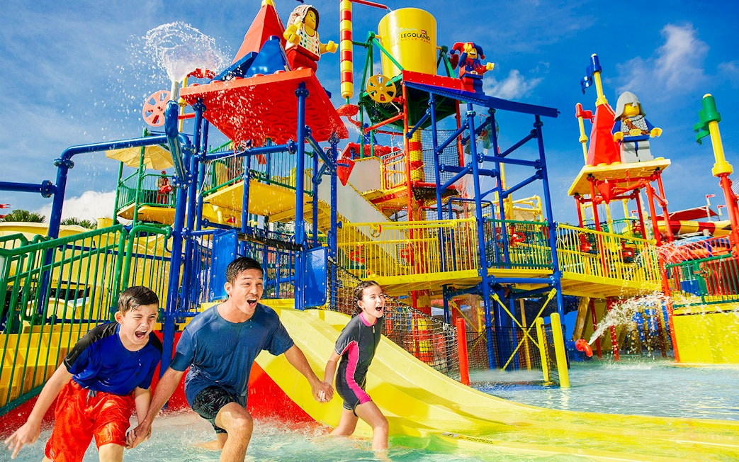 Family enjoying Joker ride at Legoland Malaysia water park.