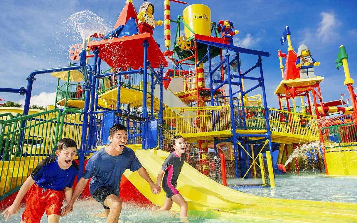 Family enjoying Joker ride at Legoland Malaysia water park.