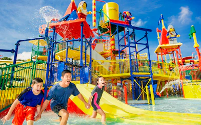 Family enjoying Joker ride at Legoland Malaysia water park.