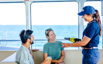 Luxurious cruise amenities including a pool deck with sun loungers and ocean views.