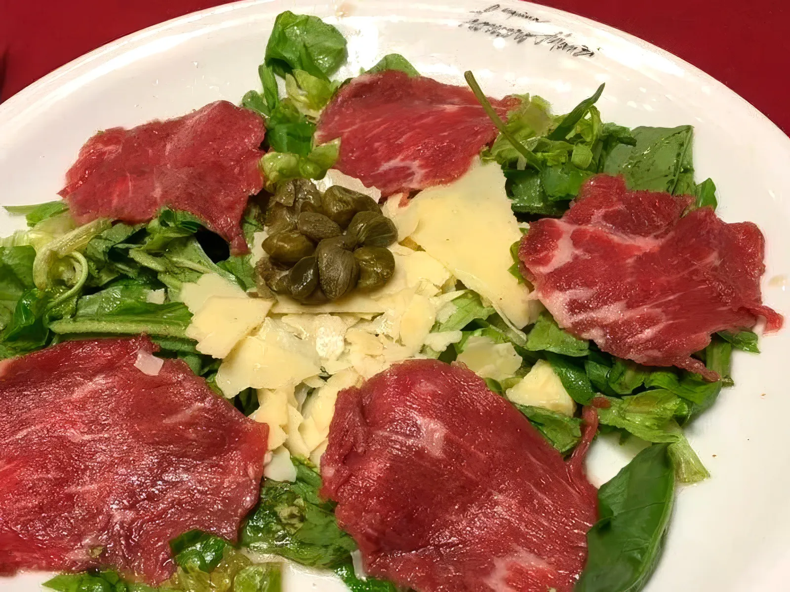 Carpaccio salad with capers and cheese served at Homero Manzi Tango show dinner.