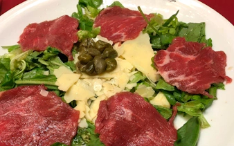 Carpaccio salad with capers and cheese served at Homero Manzi Tango show dinner.