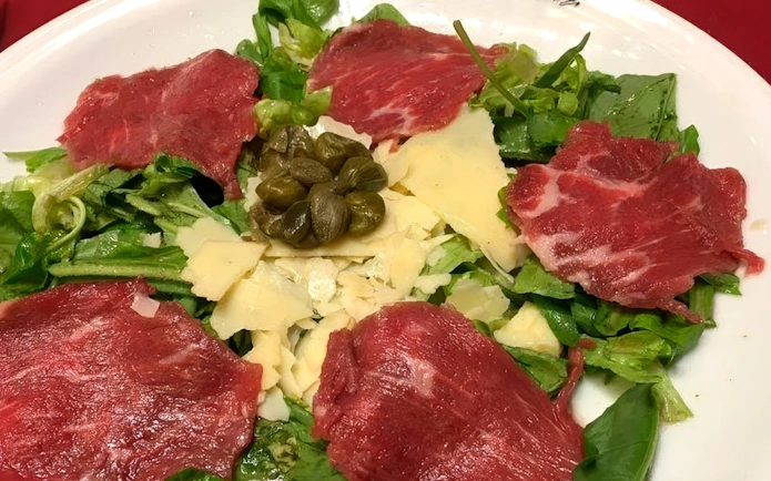 Carpaccio salad with capers and cheese served at Homero Manzi Tango show dinner.