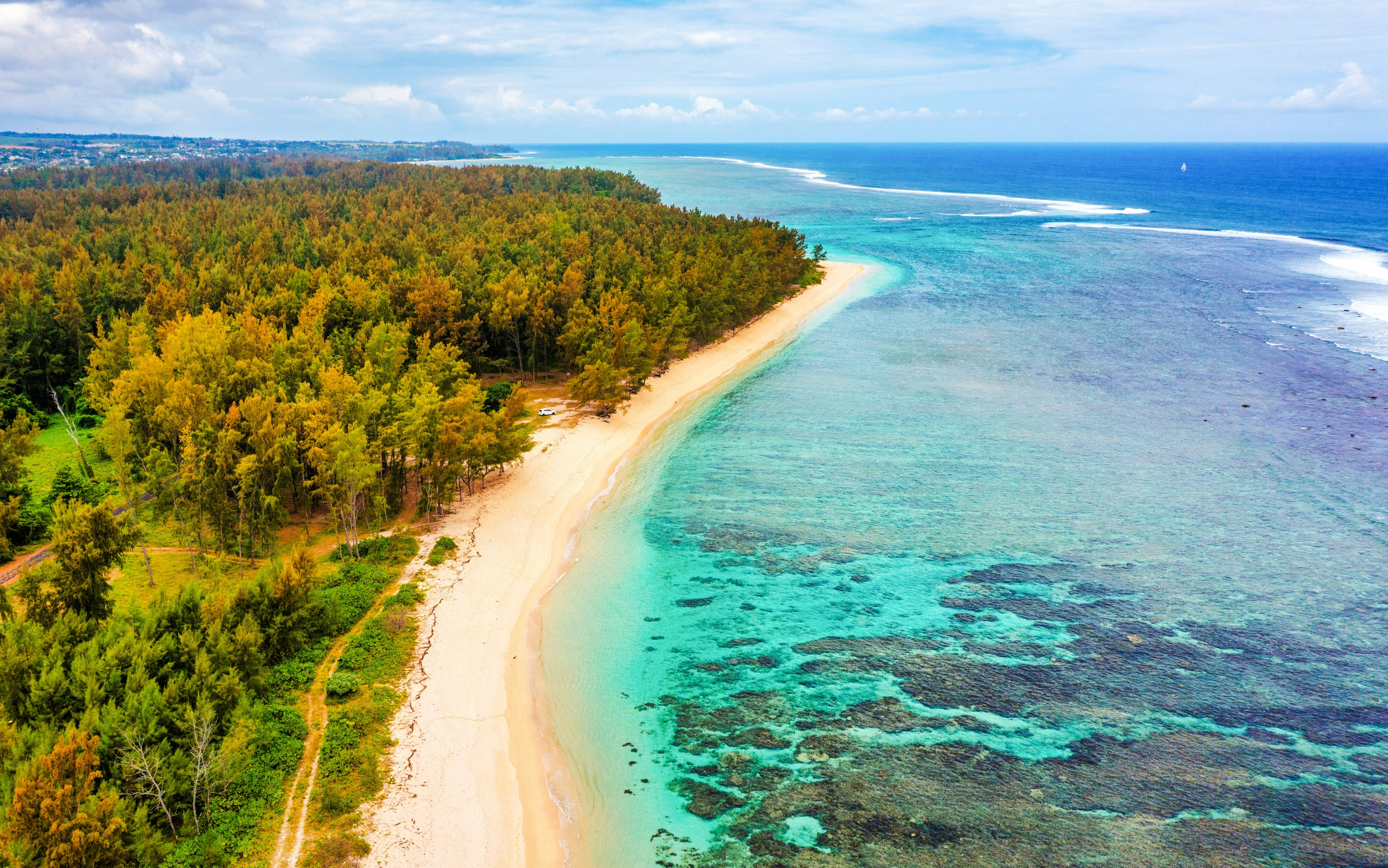 Aerial view of Palmar Beach with turquoise waters and lush greenery.