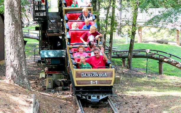 Roller coaster ride at Six Flags Over Georgia with passengers enjoying the Dahlonega Mine Train.