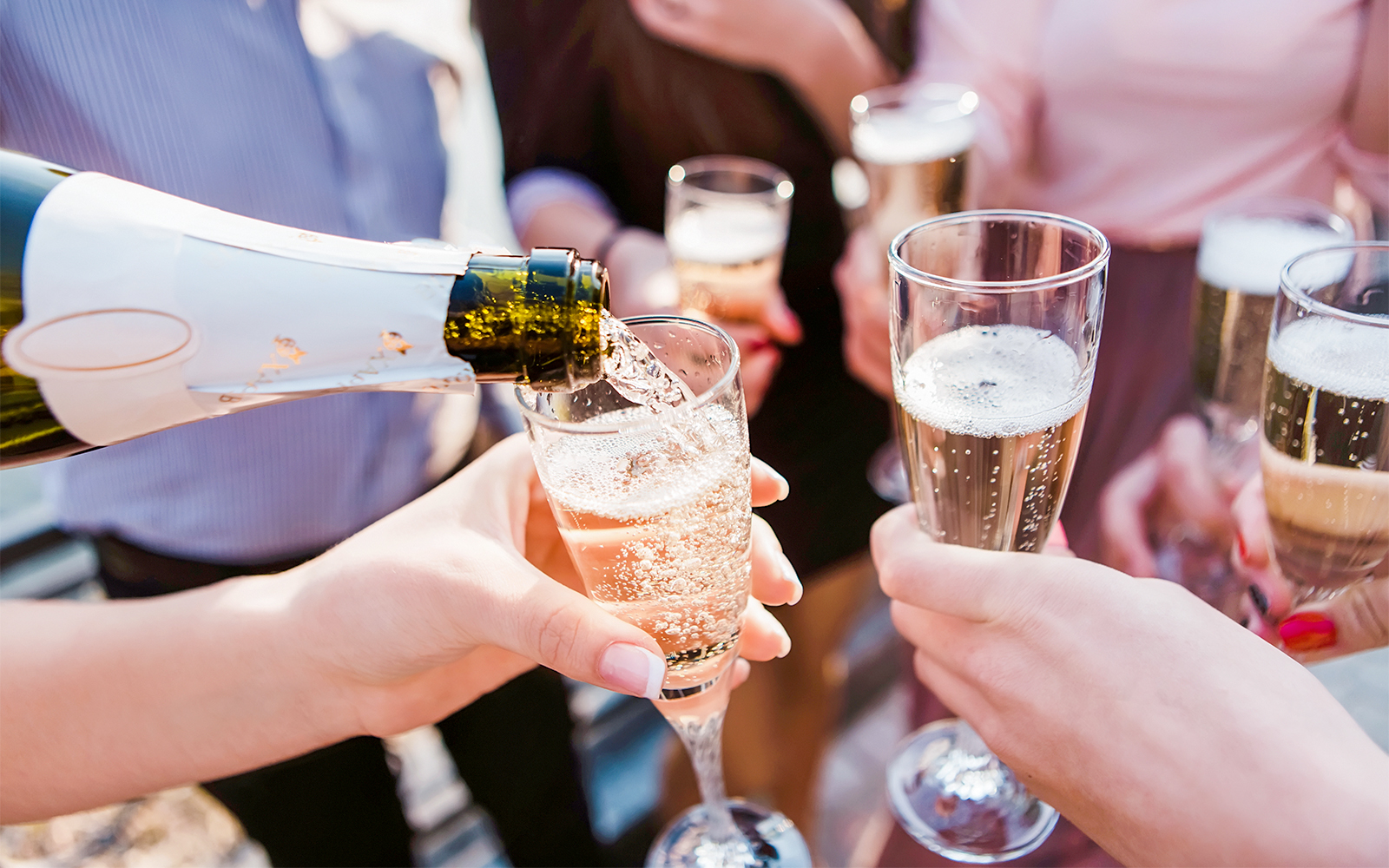 Pouring champagne into glasses at Cabaret La Nouvelle Eve spectacle.