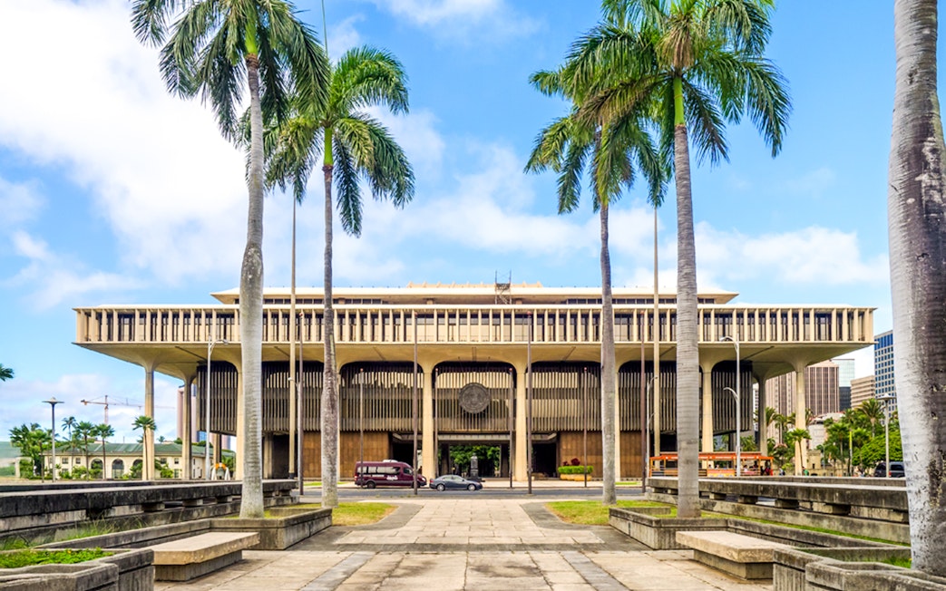 Hawaii State Capitol building with palm trees in Honolulu.