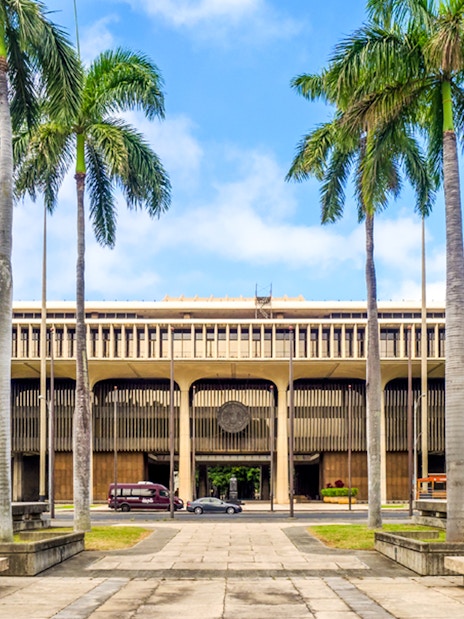Hawaii State Capitol building with palm trees in Honolulu.
