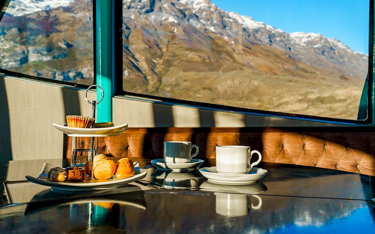 Premium boat interior with pastries and coffee, view of mountains during Perito Moreno, Spegazzini & Upsala tour.