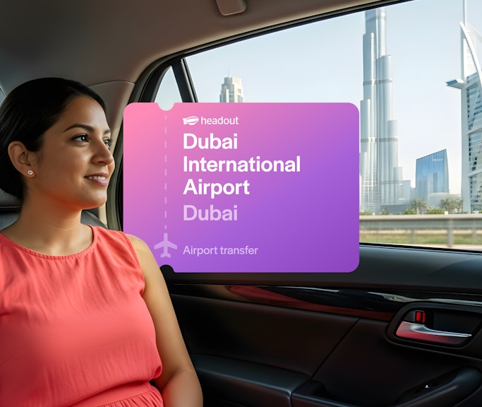 Passenger in car with view of Burj Khalifa and Burj Al Arab, Dubai airport transfer.