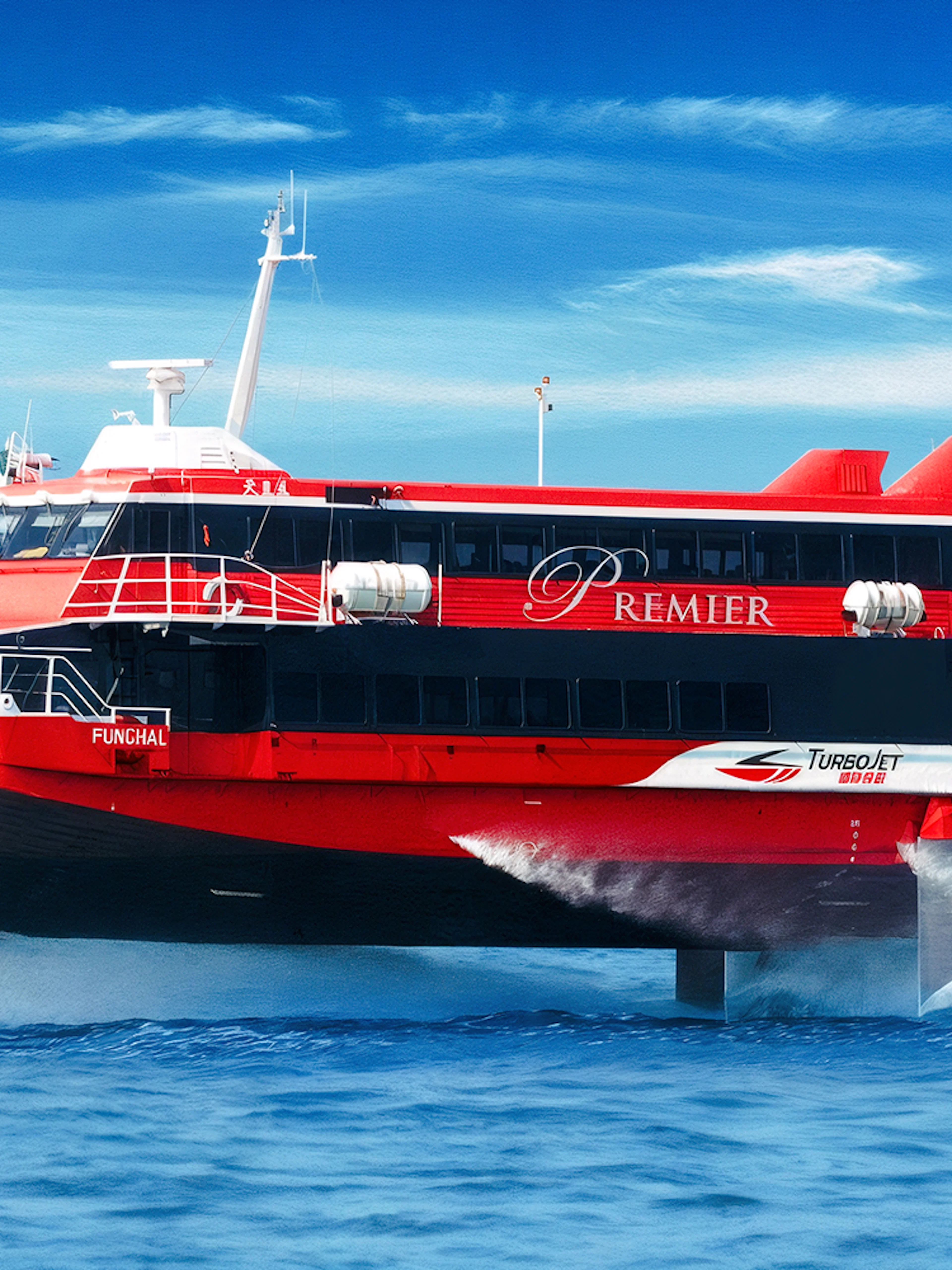 TurboJET ferry cruising from Macau to Hong Kong Island on open sea.
