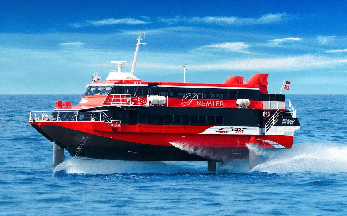 TurboJET ferry cruising from Macau to Hong Kong Island on open sea.