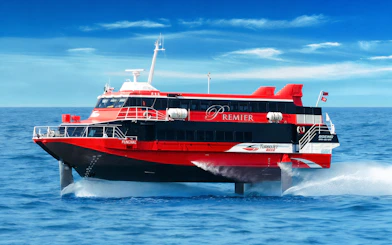 TurboJET ferry cruising from Macau to Hong Kong Island on open sea.