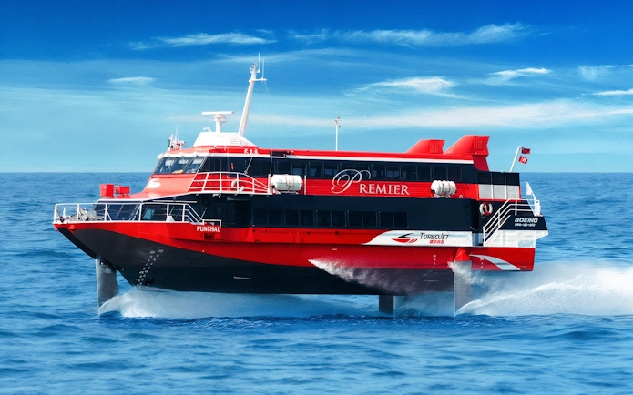 TurboJET ferry cruising from Macau to Hong Kong Island on open sea.