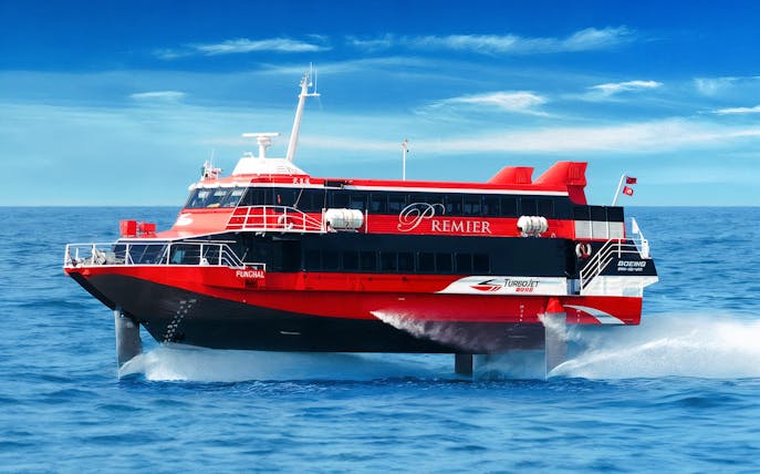 TurboJET ferry cruising from Macau to Hong Kong Island on open sea.