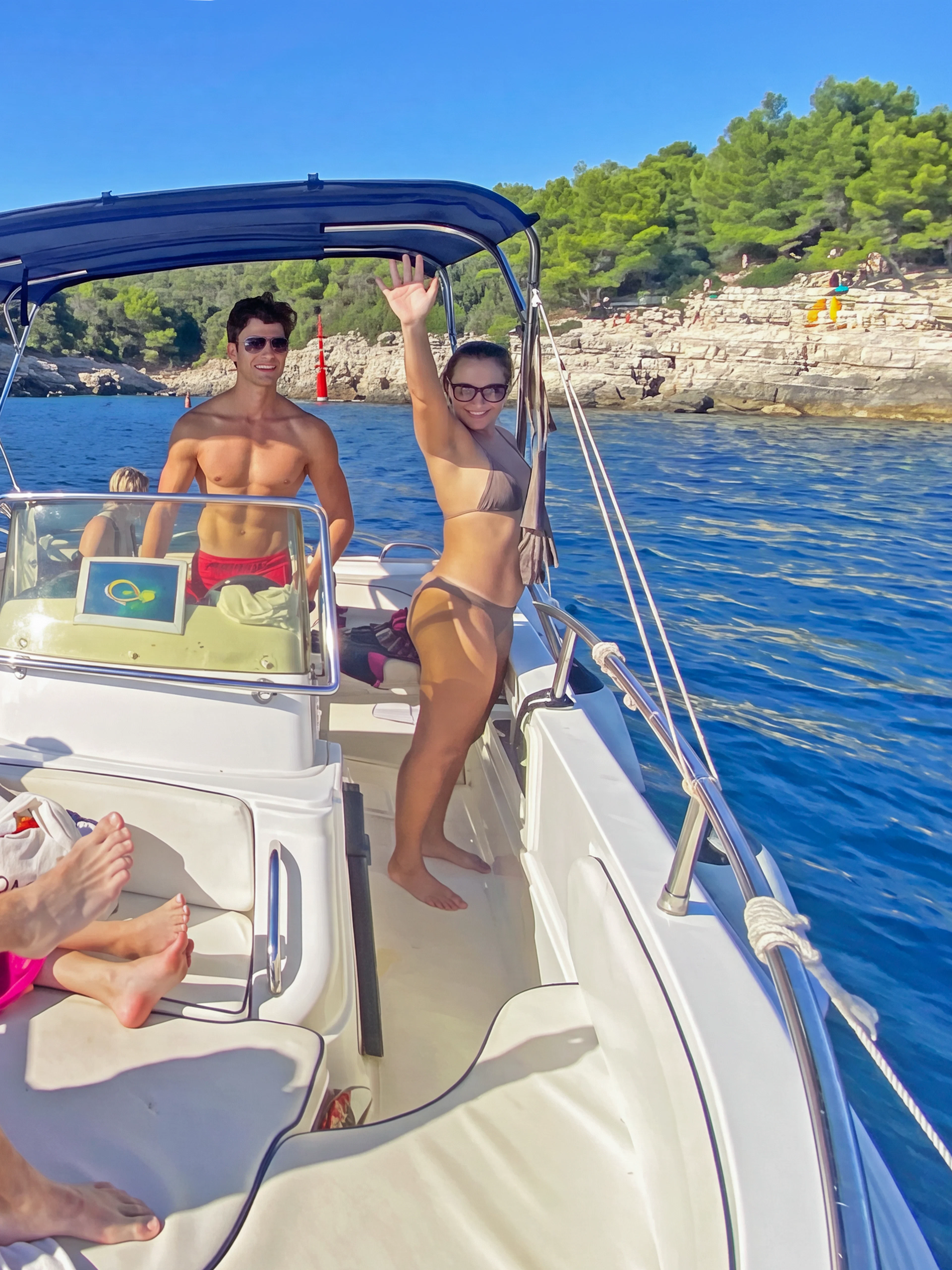 Private boat tour near Brijuni Islands with people enjoying the sun and scenic coastline.