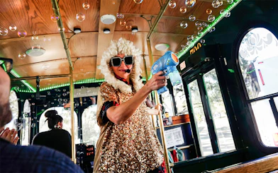 Performer in costume entertaining on Nashville comedy trolley tour.