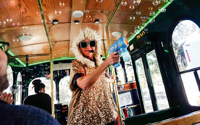 Performer in costume entertaining on Nashville comedy trolley tour.