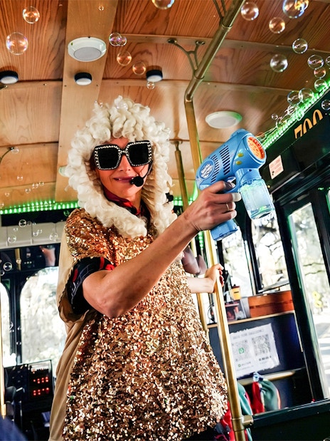 Performer in costume entertaining on Nashville comedy trolley tour.