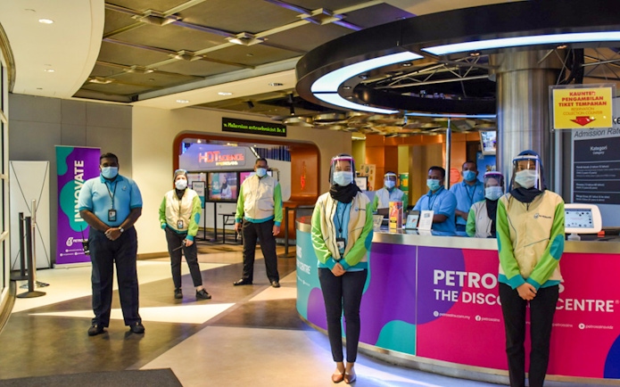 People standing at the entrance of Petrosains, The Discovery Centre in Kuala Lumpur.