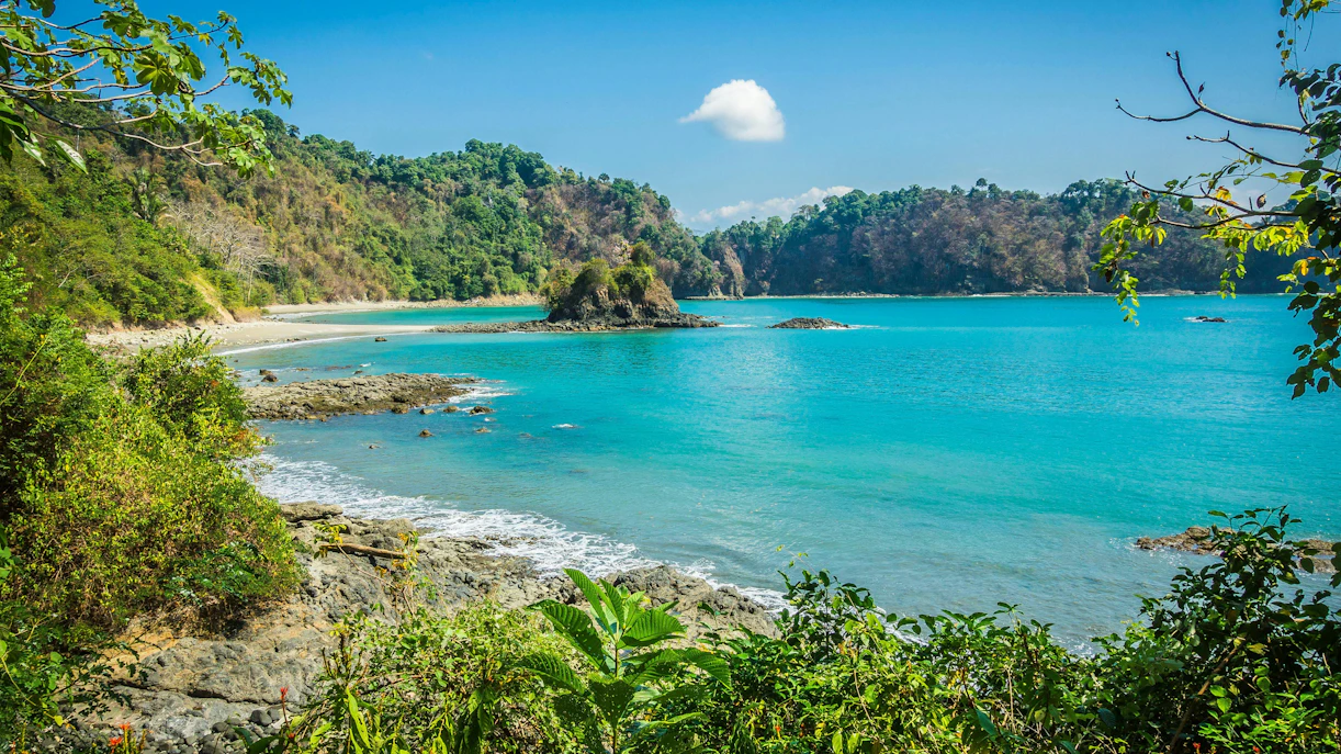 Manuel Antonio Beach with lush greenery and turquoise waters, Costa Rica.