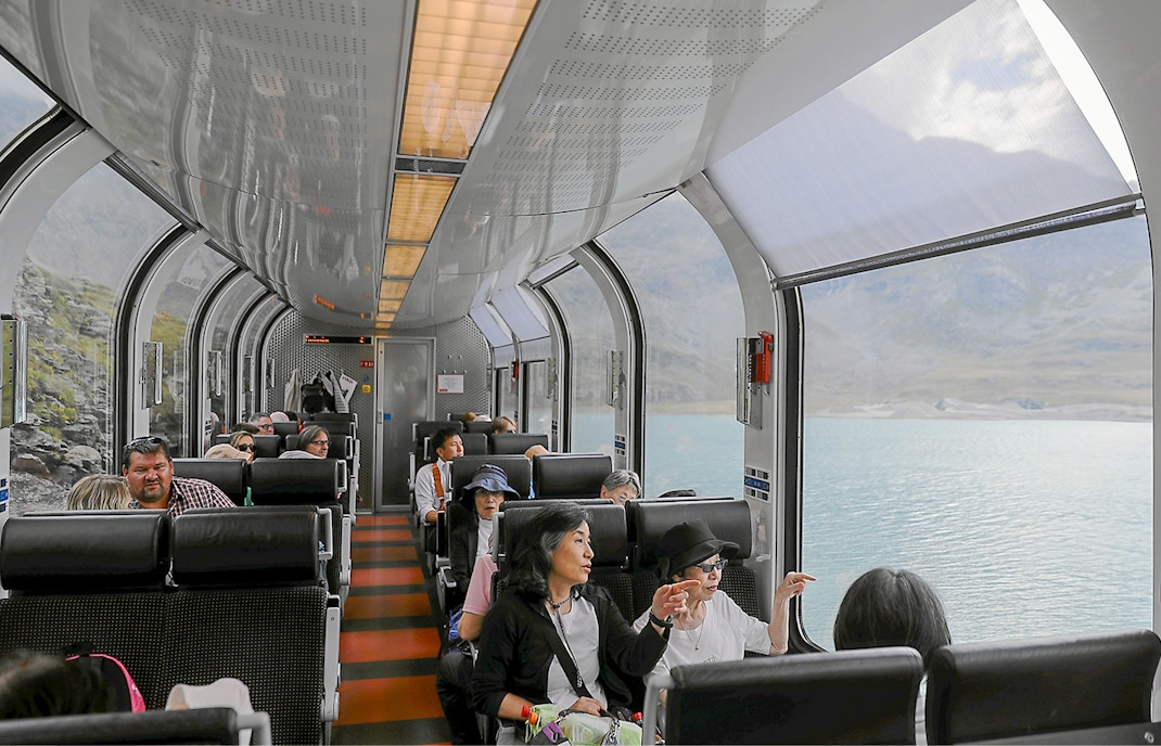Bernina Express train interior with panoramic windows and reserved seating.
