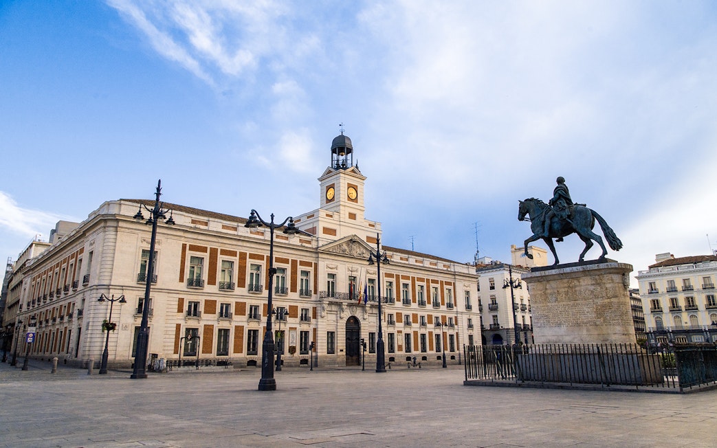 Equestrian statue and clock tower at Puerta del Sol, Madrid.