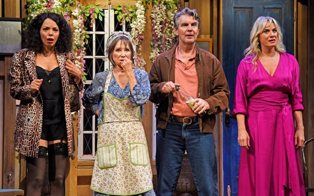 Cast members performing a scene from "Noises Off" on stage.