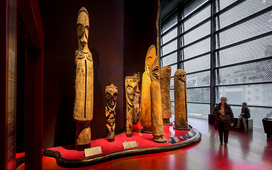 Quai Branly Museum interior with tribal sculptures, Paris.