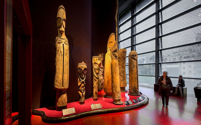 Quai Branly Museum interior with tribal sculptures, Paris.