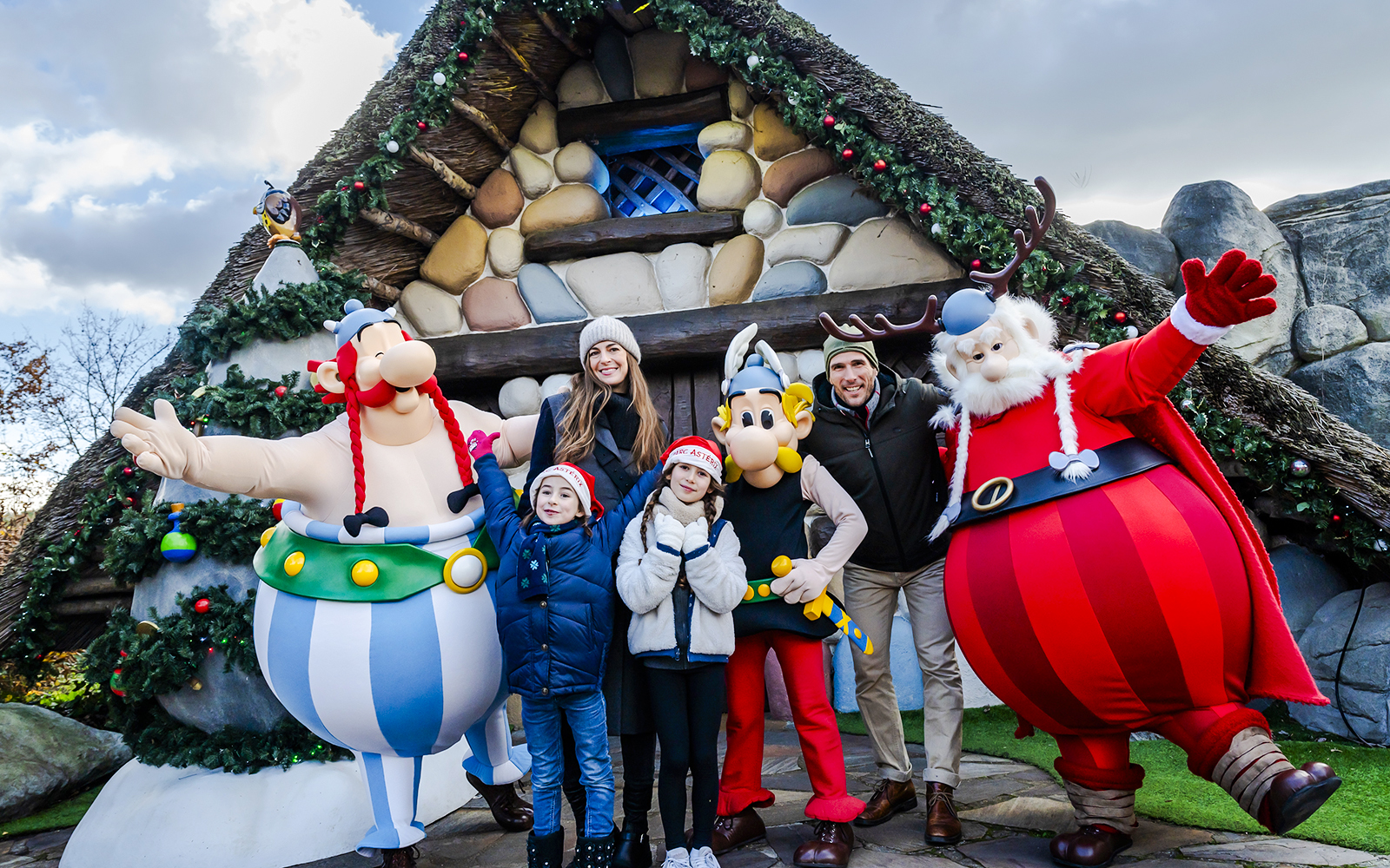 Family with Asterix characters at Parc Asterix during Christmas celebrations.