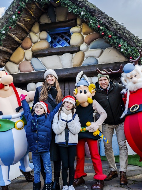 Family with Asterix characters at Parc Asterix during Christmas celebrations.
