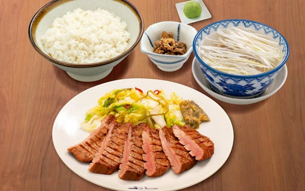 Grilled beef slices with rice, vegetables, and soup, part of JR Haruka Airport Express dining experience.