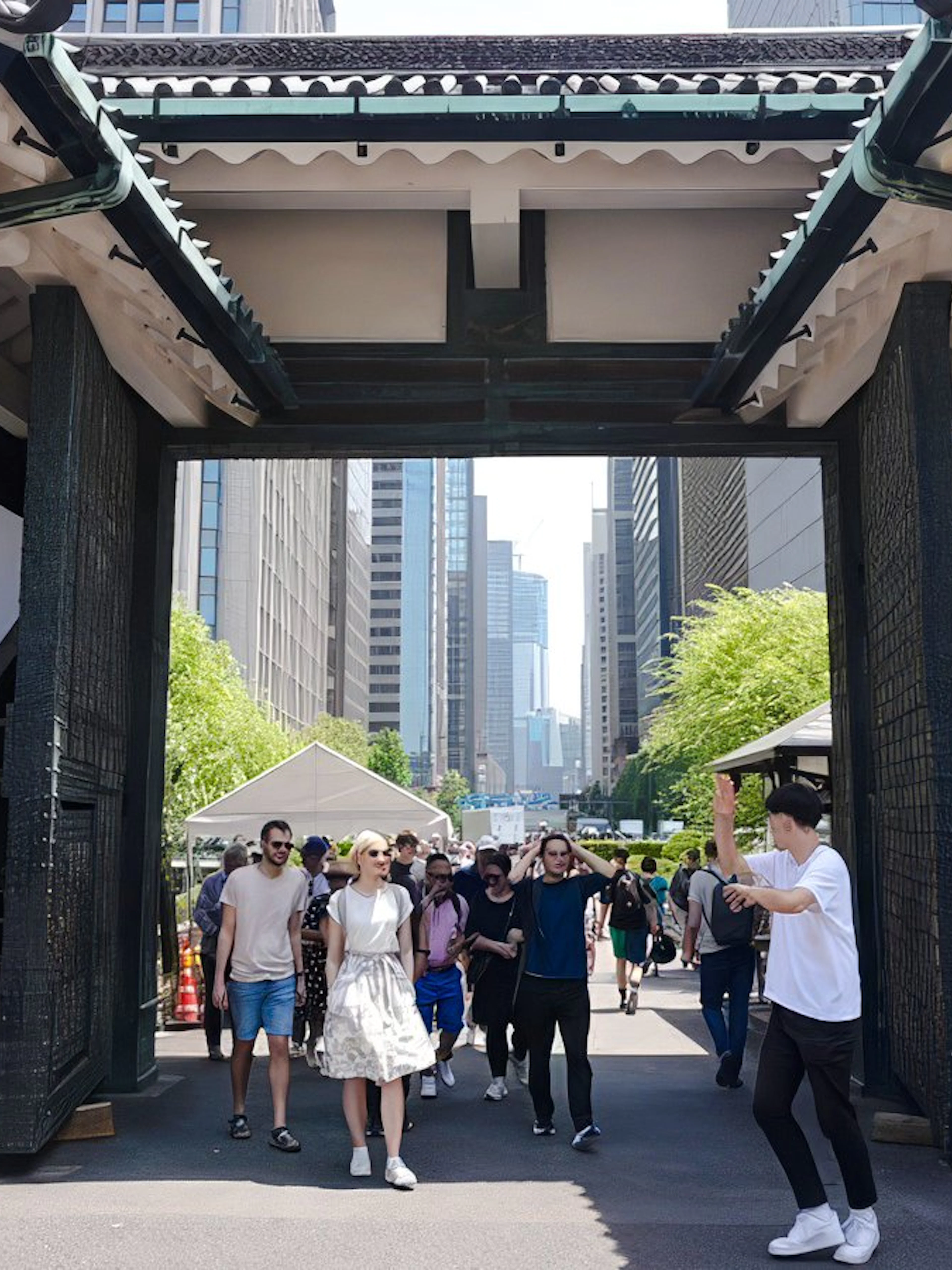 Visitors walking through the gate of Tokyo's Imperial Palace on a guided tour.